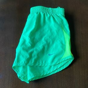 lime green and yellow Nike running shorts